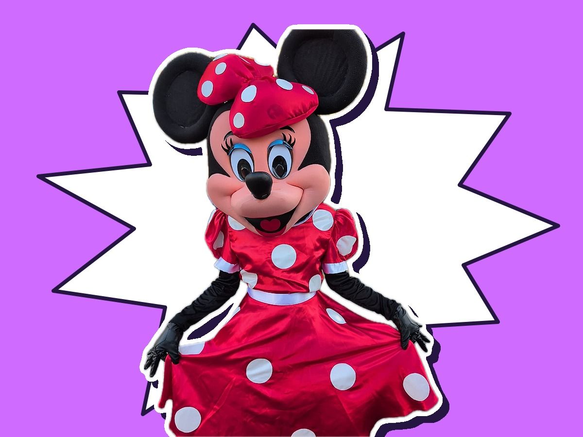 A performer as a Minnie-inspired polka dot mouse in a red dress