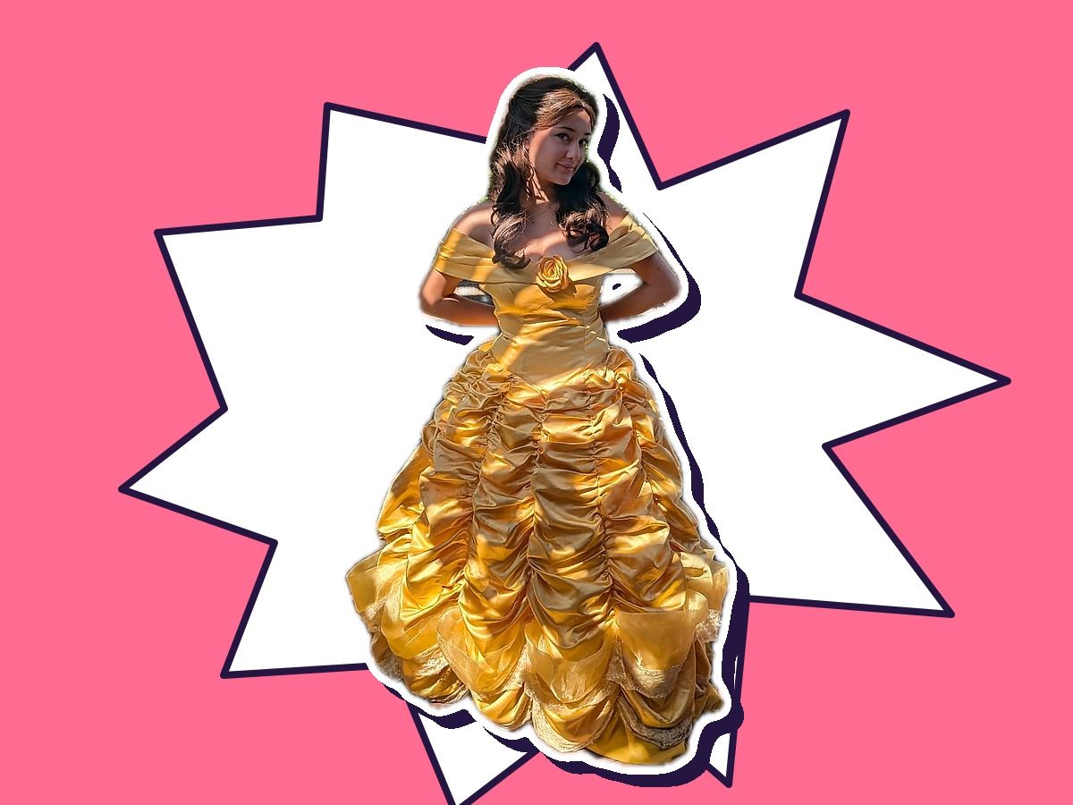 A performer as a Belle-inspired princess in a golden ballgown
